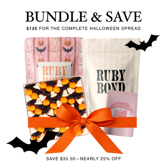 Ruby Bond Complete Halloween Spread bundle with Let's Get Batty candy board, Wicked Sweet and After Dark candy mixes, and Vampire Bites favor bags.
