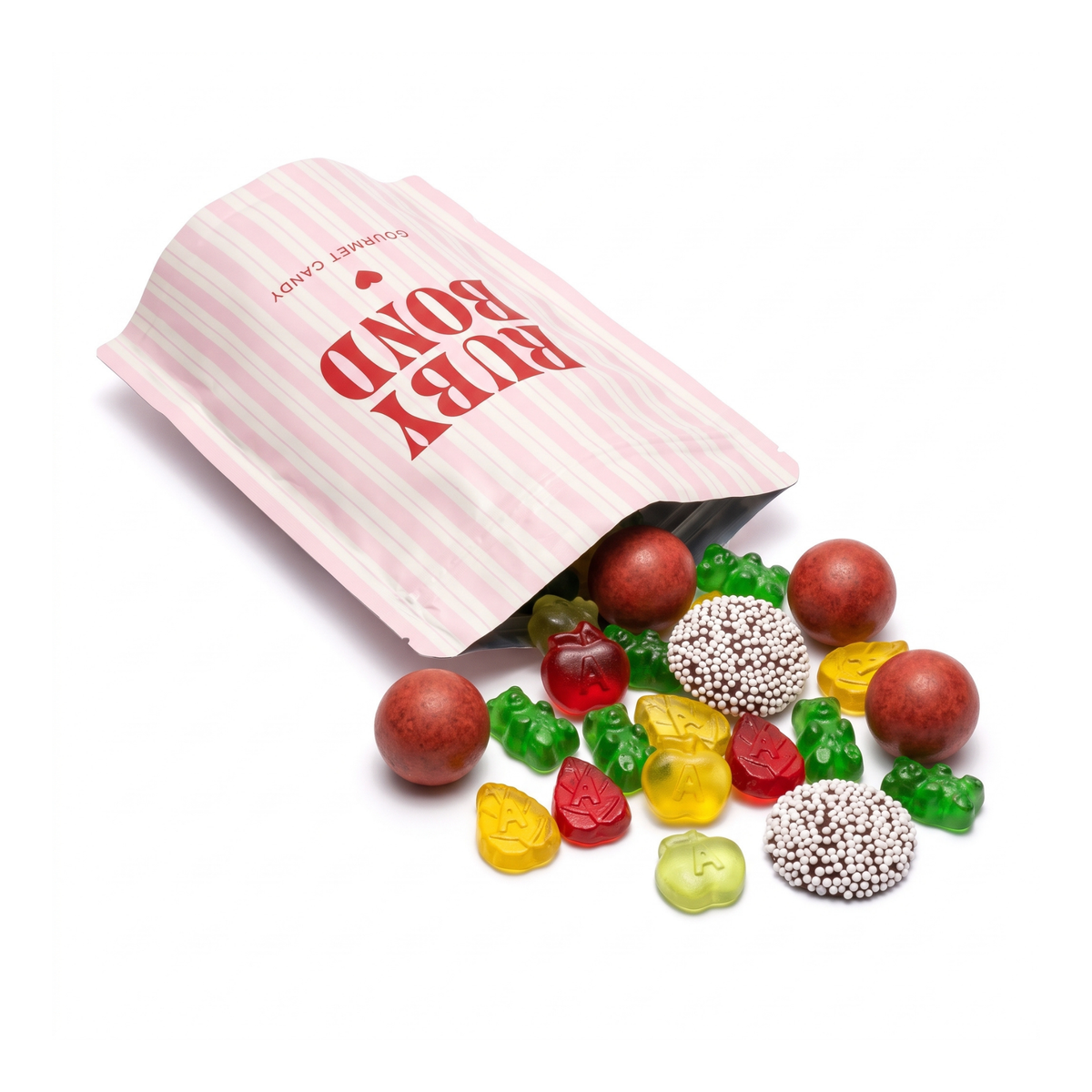 Open Ruby Bond pink-striped bag spilling The Fall Edit candy mix: pumpkin spice malt balls, apple gummies, green gummi bears and chocolate nonpareils.